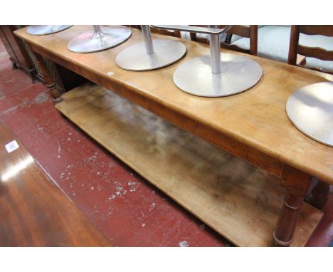 A fruitwood two tier serving table on ring turned supports 85cm high, 250cm wide