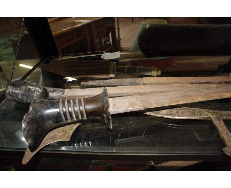 Eight Middle Eastern or Indian swords, a dagger, three spear heads, a European sabre, and a leather quiver and arrows, all as