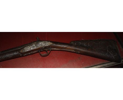 An 18ct Century Flintlock hunting gun, with elaborate filigree metal work of Aeolus, god of wind, to the stock and further me