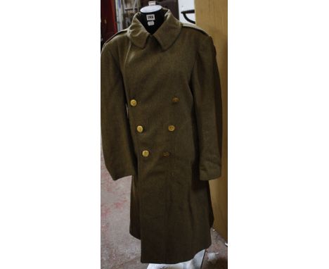 [Militaria] - A Second World War U. S. Army Field Overcoat, of heavy wool construction with built-in belt and gilt brass butt