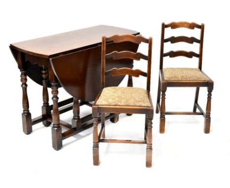 An early 20th century oak dropleaf dining table raised on turned and block stretchered supports and a set of four ladder-back