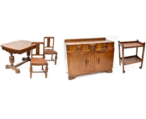 An early 20th century dining room suite comprising draw-leaf table raised on baluster legs, six chairs and matching sideboard