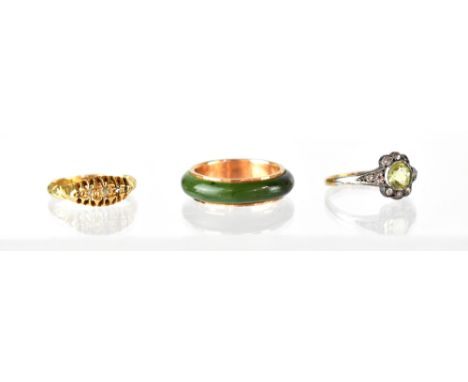 Three fashion rings including a green jade with gold sleeve marked K12, a 19th century gold and tiny diamond ring (gold grade