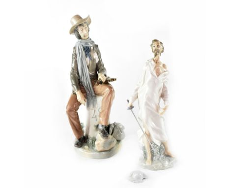A Lladró figure of a travelling musician seated on a kilometre signpost with a violin resting on his knee and a Nao figure of