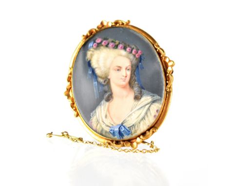 A portrait watercolour miniature of a young Georgian lady in a yellow metal scrolling frame brooch, length 5.2cm.