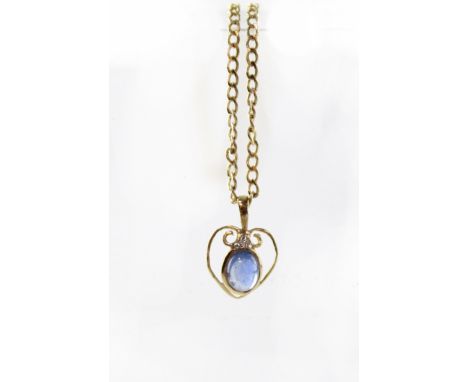 A 9ct gold pendant necklace set with cabochon sapphire and a single diamond in an Art Nouveau setting, the chain stamped '375