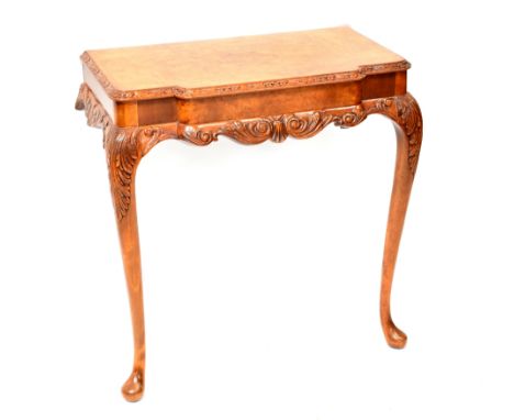 A reproduction walnut break-front console table with carved apron and acanthus leaf decorated cabriole legs to pad feet, widt