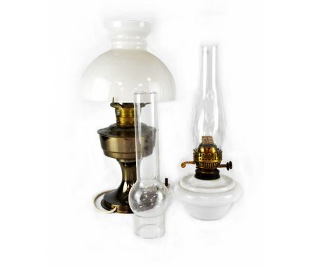 An opaque glass oil lamp with funnel and one other with metal base and opaque glass shade, height of largest 48cm (2).