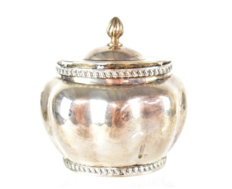 An Edward VII hallmarked silver tea caddy by Lambert &amp; Co, the lid with flame finial on circular lobed body, hallmarked f