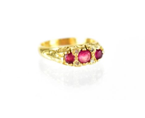 A Victorian 18ct gold ruby and diamond ring, the boat-shaped top panel set with a line of three graduated rubies inter-spaced