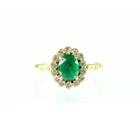 An 18ct gold cluster ring set with central oval-cut emerald surrounded by fourteen diamonds, stamped '750', approx 2.7g, in B