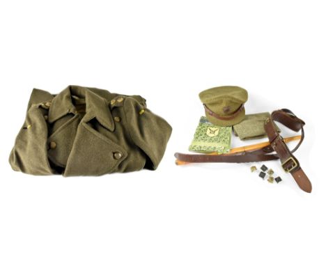 A green Army overcoat bearing label 'Flights Ltd' dated 20th August 1943, assigned to Second Lieutenant TH Jackson RASC with 