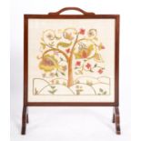A mahogany framed crewelwork fire screen
