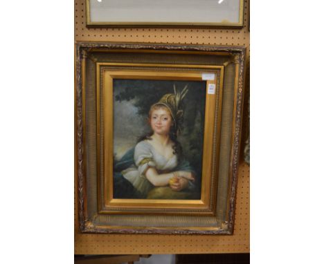 Bust length portrait of a young girl holding an apple, oiliographic print in a decorative gilt frame.