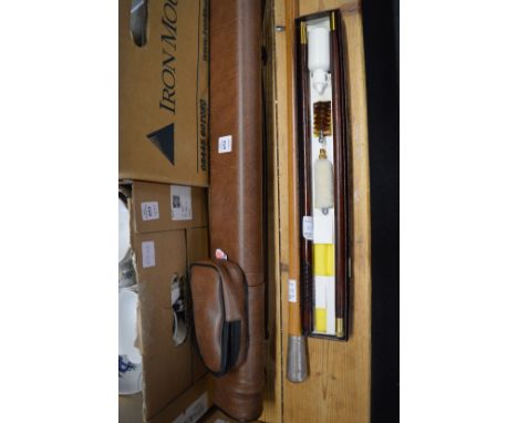 A cased pool cue, a walking stick and shotgun cleaning kit.