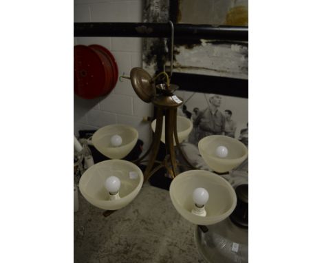 Modern five branch chandelier with opaque glass shades.