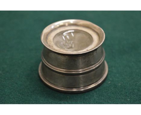 A silver inkwell.