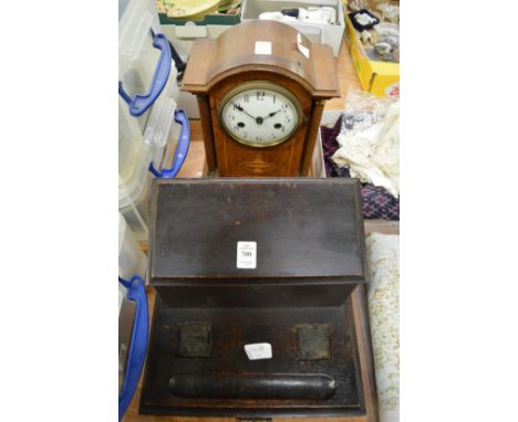 A desk stand and a mantel clock.