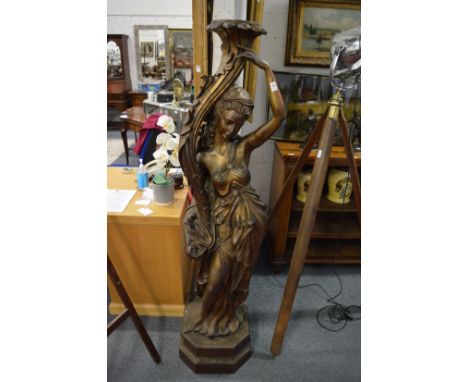 A near life size floor standing fibre glass figural lamp base.