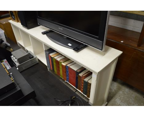 A white painted book shelf.