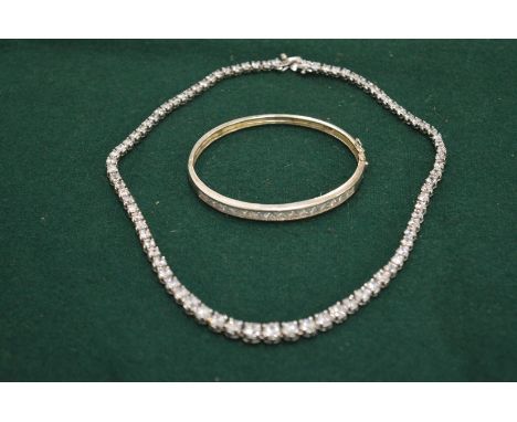 A silver and diamonti necklace and bangle.