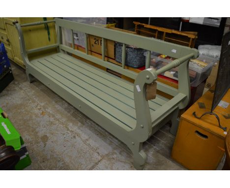 A large green painted bench.