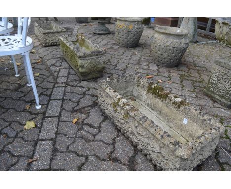 A pair of reconstituted stone garden troughs and a similar trough.