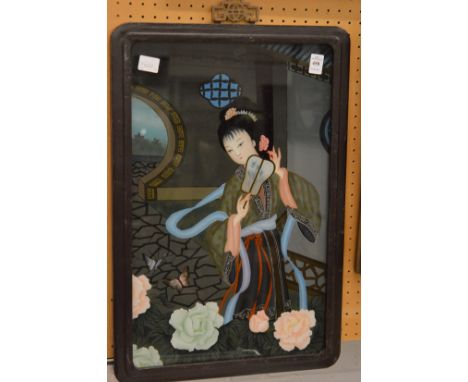 A Chinese reverse painting on glass depicting a young lady with a fan.