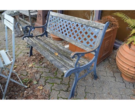 A cast metal and wooden garden bench.