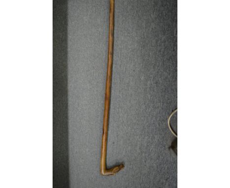 Walking stick carved with a horses head.