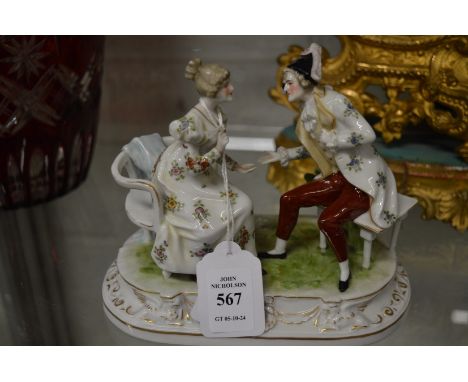 A Sitzendorf porcelain group of a seated gentleman and lady.