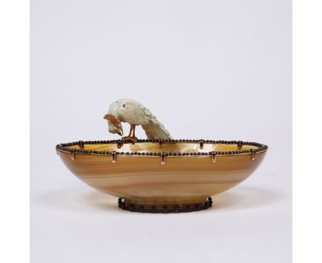 An early 20th Century banded agate oval bowl mounted with an enamel peacock having diamond set plumage, the bowl bordered by 