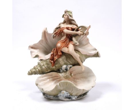 A Royal Dux porcelain model of a maiden resting on two shells playing a lyre, 36cm high