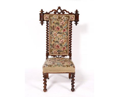 A Victorian rosewood prie-dieu with tapestry upholstery, 129cm high, 68cm wide