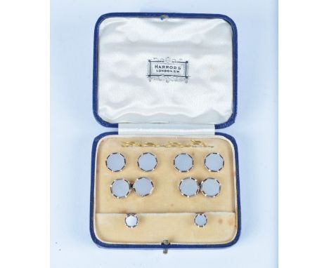 A set of 9ct and 18ct gold studs with engine turned decoration by Harrods of London in original box