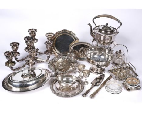 A collection of miscellaneous silver plated wares including a spirit kettle, entree dishes, sauce boats, a rose bowl, toast r