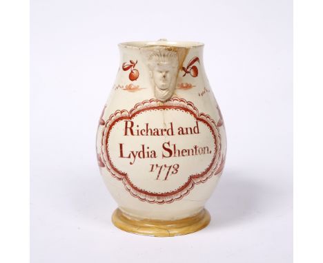 An 18th Century creamware jug possibly Leeds, painted with two figures each holding a glass of wine and a lady smoking a pipe