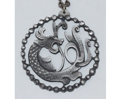 A Jorgen Jensen Celtic design pewter pendant modelled as a dragon, with beaded rim, on necklace chain, stamped verso '97' Den