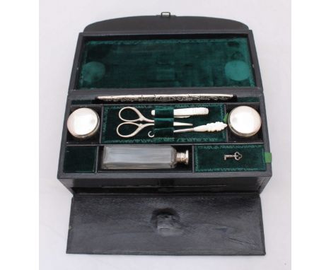 A ladies travelling vanity case including scissors, mother-of-pearl penknife and glove hook, two cream jars, scent bottle, sl