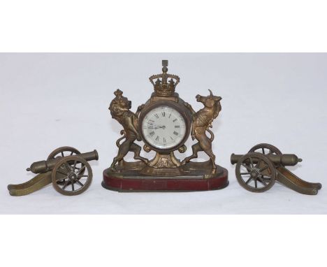 A small gilt brass mantel clock modelled as the Lion and Unicorn from the Royal Coat of Arms, supporting the circular timepie