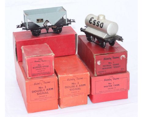 Six Hornby Trains O-gauge comprising 1x Hopper Wagon R166, 1x No1 Petrol Tank Wagon 'Esso,' 1x No.1 Water Tank, 2x No.2 Doubl