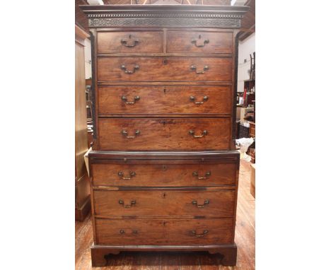 An 18th century mahogany chest on chest, the top section with a shaped cornice, decorated with dentil moulding, above a set o