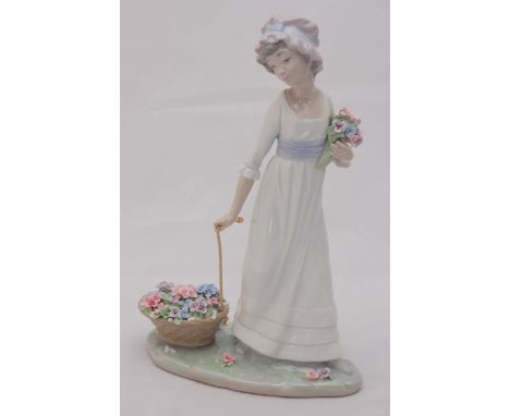 A boxed Lladro porcelain figure of a lady with flowers, 'no. 5030', 27cm high.