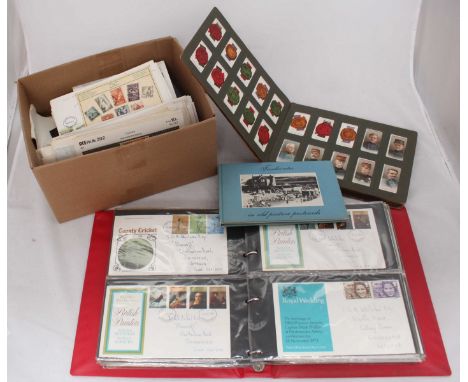A collection of approximately 240 First Day Covers across two binders and some loose, together with an album of assorted ciga
