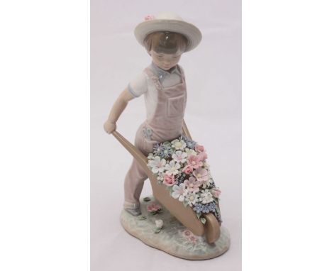 A boxed Lladro porcelain figure of a child with a wheelbarrow of flowers, 'no.1283', 24cm high.
