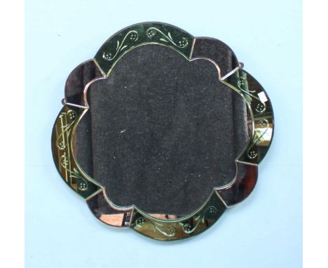 An Art Deco style green and clear mirror, shaped as a stylized flower. 72cm diameter.