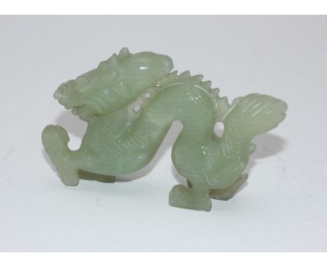 A carved jade figure of a dragon, 12cm long.