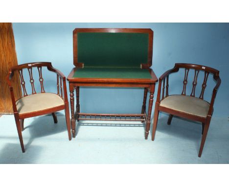 An Edwardian mahogany folding card table, the top lifting to reveal a green playing baize, together with a pair of parlour ch