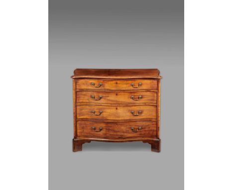 A George III mahogany serpentine dressing chest in the manner of Thomas Chippendale, the top with a moulded edge above four l
