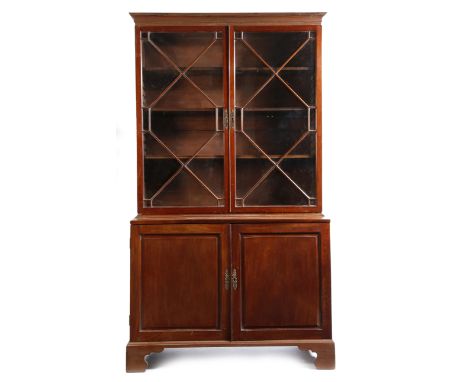 A George II mahogany bookcase cabinet, with a pair of astragal glazed doors enclosing three adjustable shelves, the base with